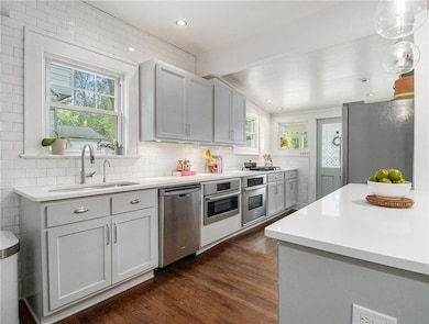Kitchen with dark hardwood / wood-style flooring, 