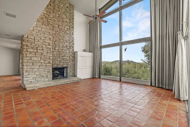 Unfurnished living room featuring a towering ceil
