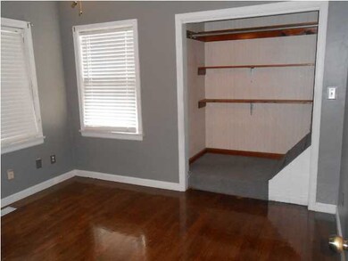 Spacious master bedroom with hardwood floors.