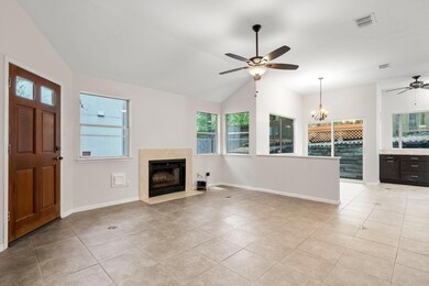 Unfurnished living room featuring ceiling fan, a 