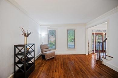 Sitting room with ornamental molding, wood finishe