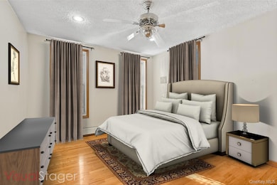 Bedroom with ceiling fan and hardwood floors