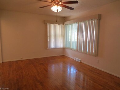 View of the living room; vertical blinds, ceiling 