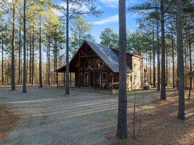 Log home featuring a porch and central AC