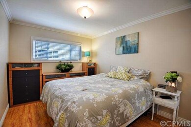 Bedroom with crown molding and sliding mirrored cl