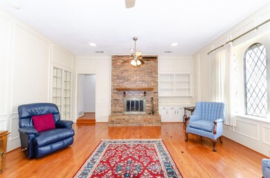 Living area with a decorative wall, a fireplace, b