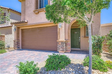 Entrance to property featuring stone siding, stucc