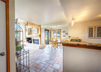 Living room with a fireplace, a textured ceiling,