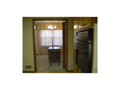 Dining room has doors that open to kitchen.