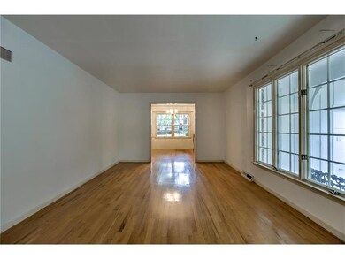 Living Room with original oak floors and large pic