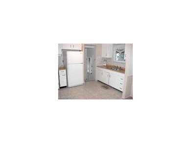 A ceiling fan, newer kitchen flooring and ample ca