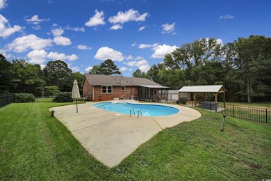 View of swimming pool with a yard and a patio area