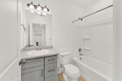 Bathroom featuring bathtub / shower combination and vanity