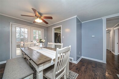 French doors and ceiling fan are featured in the d