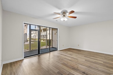 Empty room featuring ceiling fan, visible vents, b