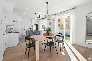 Open and inviting living and dining space just off the kitchen, filled with natural light—perfect for entertaining or enjoying gatherings with friends and loved ones.*Model