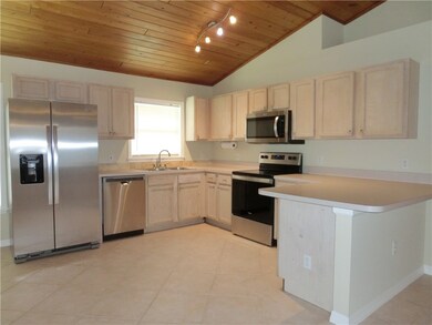 Open kitchen with new stainless appliances