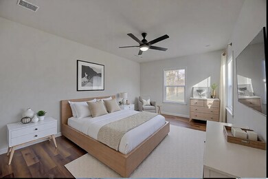 Bedroom with dark hardwood / wood-style flooring a