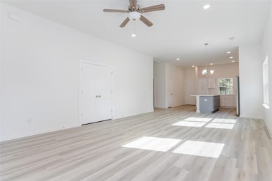 Unfurnished living room featuring light hardwood /