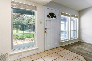 Foyer with light wood-style floors and baseboards