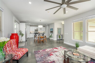 Living area with recessed lighting, finished conc