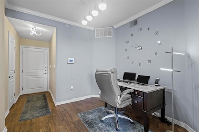 Office with wood finished floors, ornamental moldi