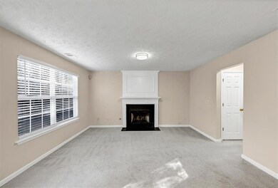 Unfurnished living room with a fireplace, a textur