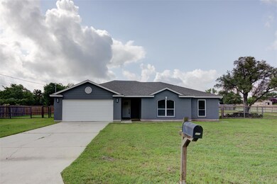 Ranch-style house with an attached garage, concre
