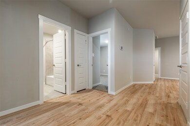 Hallway with access to bedrooms, bathroom, and sto