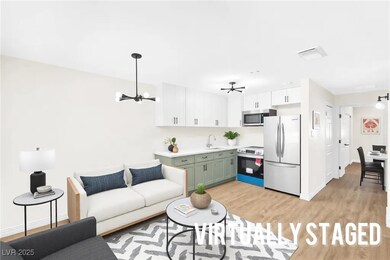 Living area featuring baseboards, light wood-type
