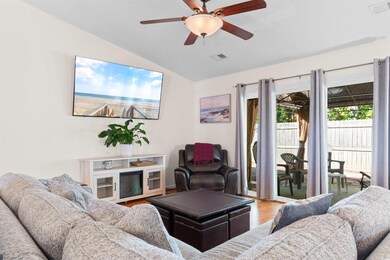 Living area featuring lofted ceiling, wood finishe