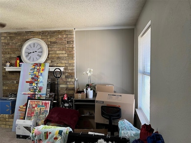 Office area with carpet and a textured ceiling