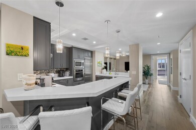 Kitchen featuring a peninsula, built in appliances