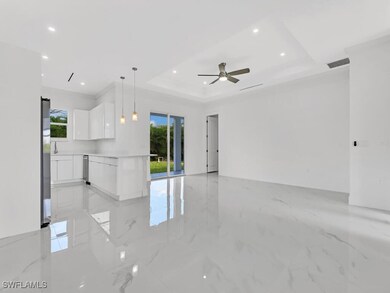 Unfurnished room featuring a tray ceiling, light m