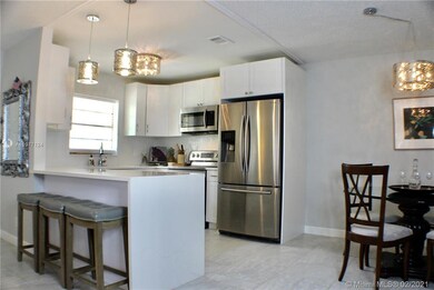 Open kitchen with quartz waterfall counter tops