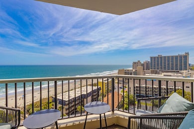 Balcony with a water view and a beach view