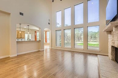 Unfurnished living room featuring arched walkways