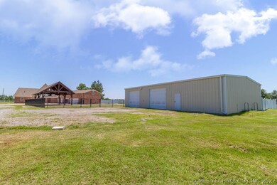 Back side of the house, shows shop, pool, and home