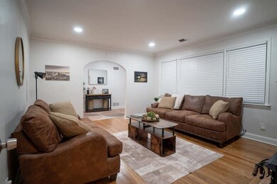 Living room with light hardwood / wood-style floor