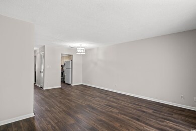 Unfurnished room with dark hardwood / wood-style f