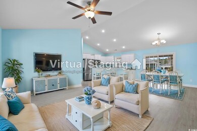 Living room featuring ceiling fan with notable cha