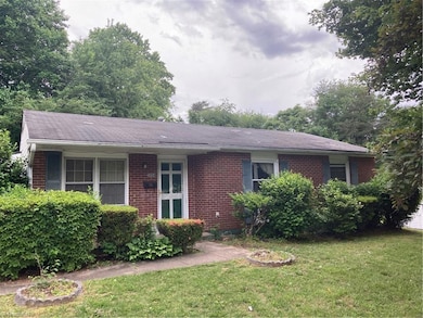 Walking up to the house shows a brick front and ranch layout: both popular with Winston Salem homebuyers.  Disclosure: 1 of six shutters is missing.