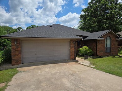 Ranch-style house with brick siding, driveway, a s