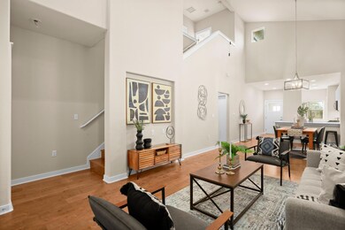 Living room featuring light wood-style floors, ba