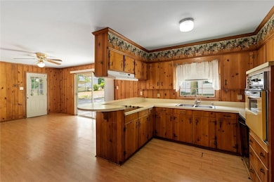 Kitchen featuring a sink, electric cooktop, oven, 