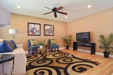 Wood laminate floors in living room with newer cei