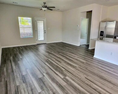 Unfurnished living room with dark wood finished f