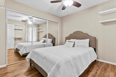 Bedroom featuring a closet, a ceiling fan, and wood finished floors