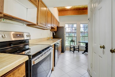 The 5x14 SF kitchen has refrigerator, stove and di