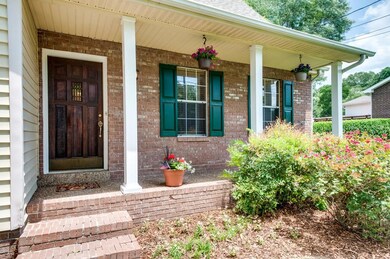 You'll LOVE this covered front porch.  Freshly painted shutters and beautiful wooden front door.